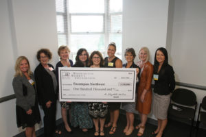 Executive Director Nela Cumming receiving the $100,000 check from the WWF