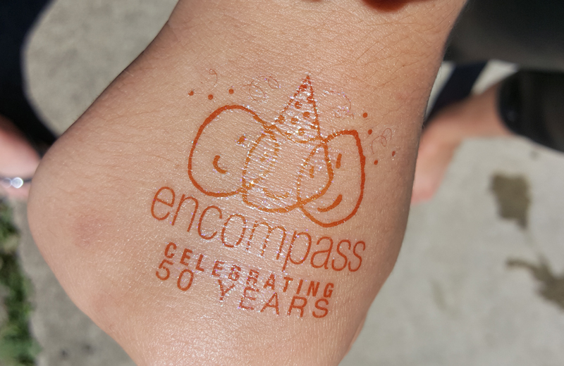 Hand with an Encompass logo on it