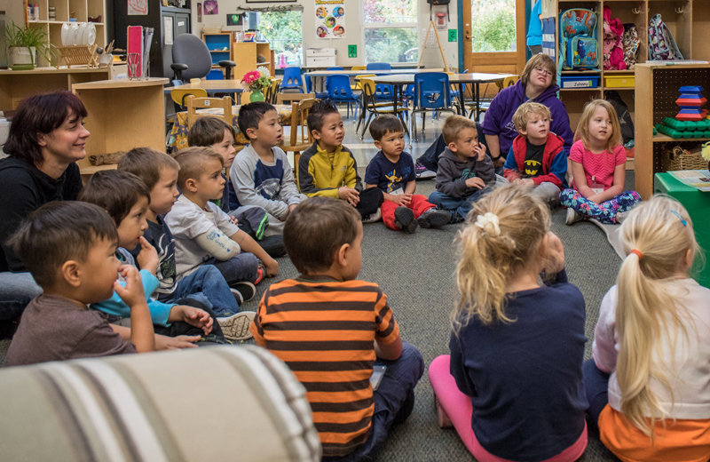 A group of preschoolers sit in a circle