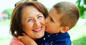 Little boy kissing grandma on the cheek