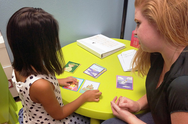 Girl working with speech therapist
