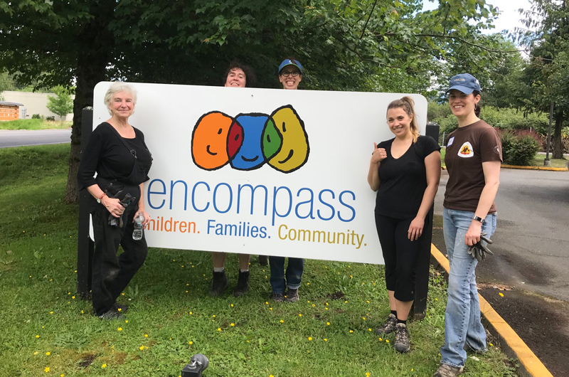 Group of volunteers with Encompass sign