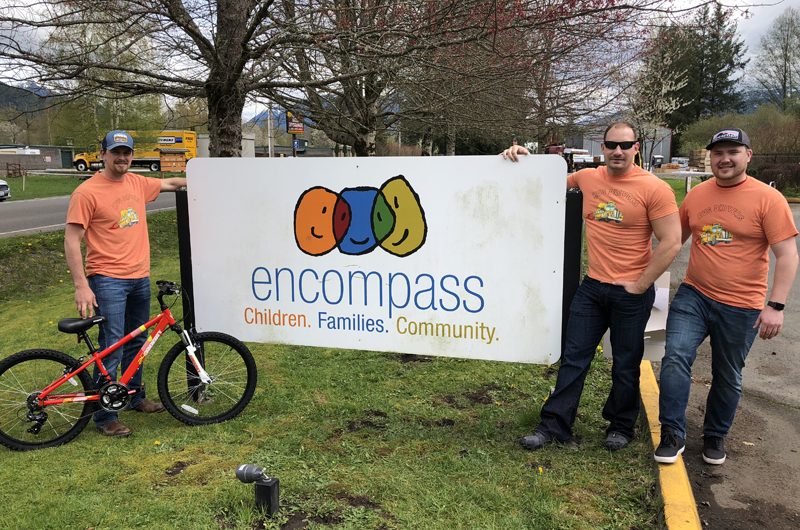 Group of volunteers with Encompass sign