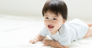 Baby smiling and crawling on the floor