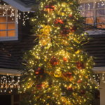 A tree lit up with lights and ornaments