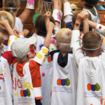 Group of kids with their hands in the air