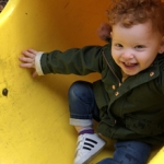 Little girl on a playground slide