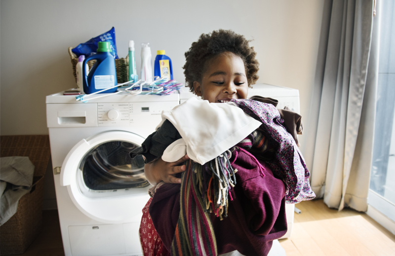 Child helping with laundry